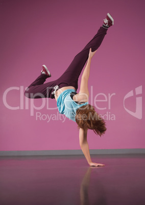 Pretty break dancer doing handstand with one hand
