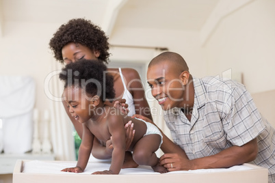 Happy parents with their baby girl in the park