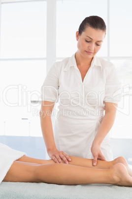 Female masseur massaging womans leg