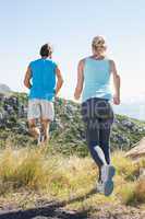 Fit couple jogging on a country trail