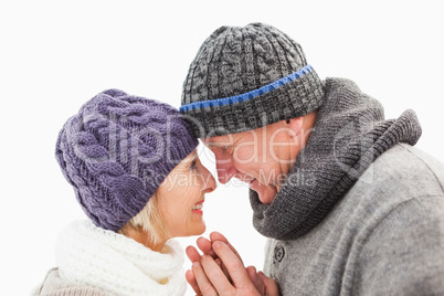 Happy mature couple in winter clothes embracing