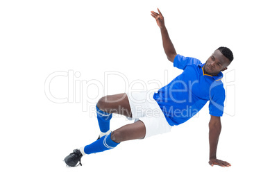 Football player in blue kicking