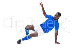 Football player in blue kicking