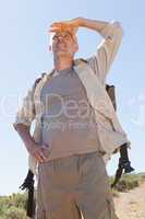 Handsome hiker looking ahead in the countryside