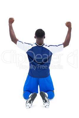 Football player in blue celebrating a win