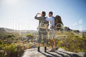 Hiking couple looking out over country terrain