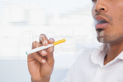 Businessman smoking an electronic cigarette