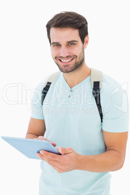 Handsome student using his tablet pc