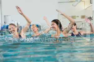 Female fitness class doing aqua aerobics