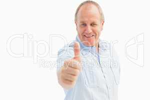 Happy mature man showing thumbs up to camera
