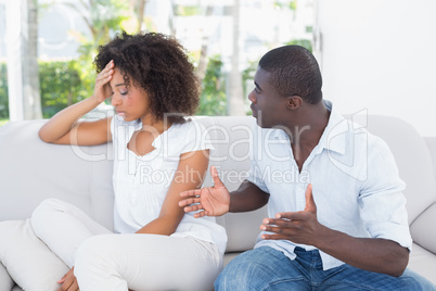 Attractive couple having an argument on couch Attractive couple having an argument on couch