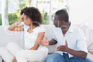 Attractive couple having an argument on couch