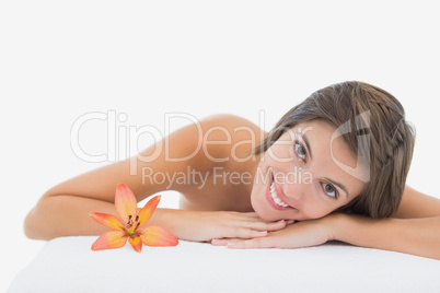 Close up portrait of a beautiful young woman on massage table