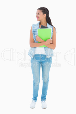 Pretty student smiling and holding notepad