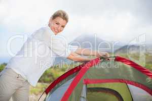 Attractive blonde setting up her tent
