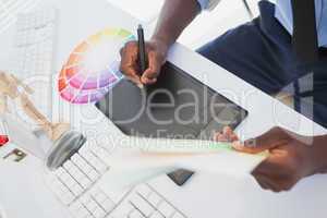 Designer sitting at his desk working with digitizer