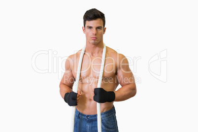 Portrait of a serious shirtless young muscular man