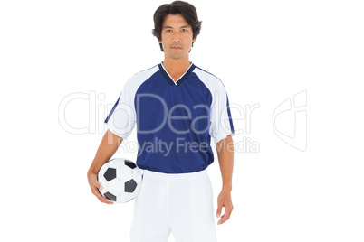 Football player in blue holding ball