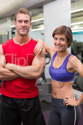 Fit attractive couple smiling at camera