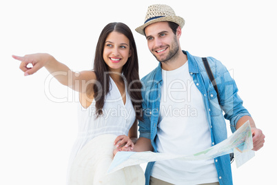 Happy hipster couple looking at map