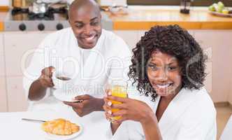 Happy couple having breakfast together at table