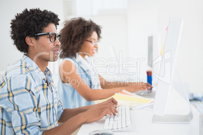 Happy design team working at desk