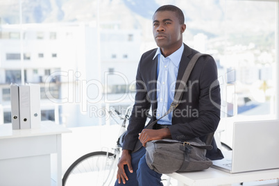 Thoughtful businessman with his bicycle Thoughtful businessman with his bicycle