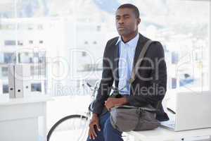 Thoughtful businessman with his bicycle