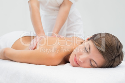 Attractive woman receiving back massage at spa center