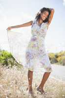 Beautiful woman in floral dress smiling at camera