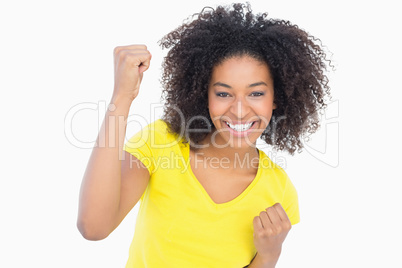 Pretty girl in yellow tshirt cheering at camera