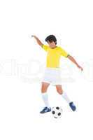 Football player in yellow kicking ball