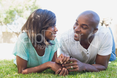 Happy couple lying in garden together