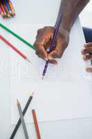 Man drawing with colour pencils