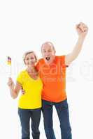 Happy german couple cheering at camera