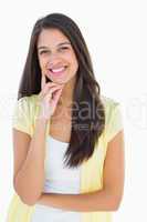 Happy casual woman thinking with hand on chin