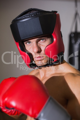 Male boxer in defensive stance in health club