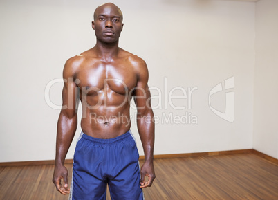 Serious shirtless young muscular man