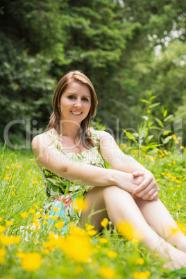 Cute young woman relaxing in field