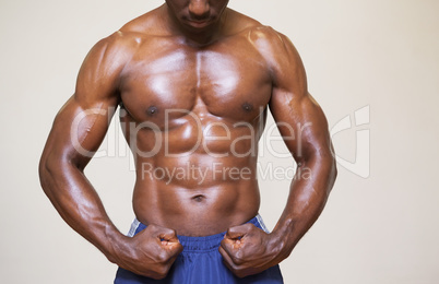 Shirtless young muscular man flexing muscles