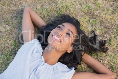 Casual pretty woman lying on the grass
