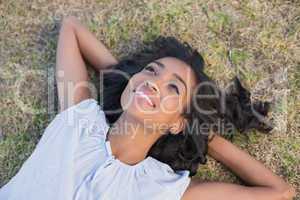 Casual pretty woman lying on the grass