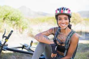 Fit woman taking a break on her bike ride