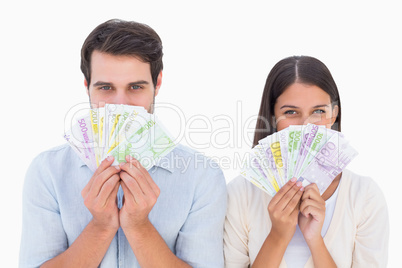 Happy couple showing their money