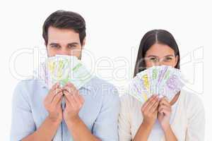 Happy couple showing their money