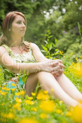 Cute young woman relaxing in field