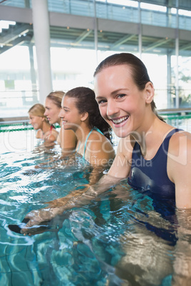 Female fitness class doing aqua aerobics