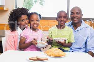 Happy family having breakfast together in the morning