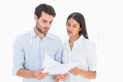 Attractive young couple reading their bills