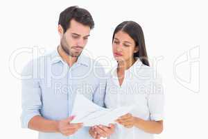 Attractive young couple reading their bills